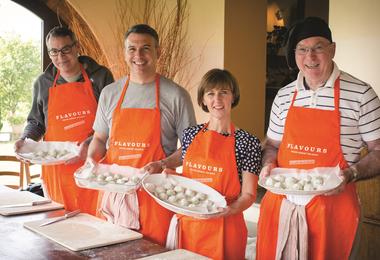 Guests cooking together on a Flavours Holidays trip