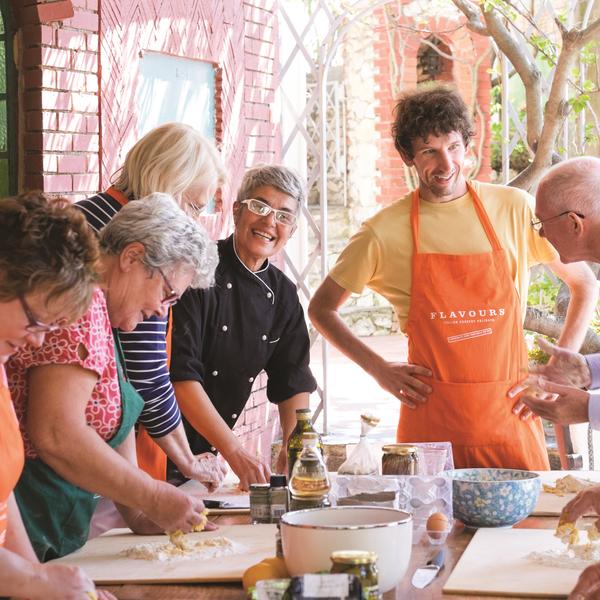Guests cooking together on a Flavours Holidays trip