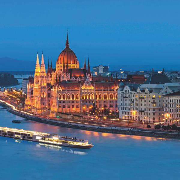 Scenic Amber sails past Budapest's parliament at dusk